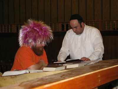 Aaron Kagan participates in the reading of the Megillah with Rabbi Galperin Rabbi Galperin and Aaron Kagan reading from the Megillah
